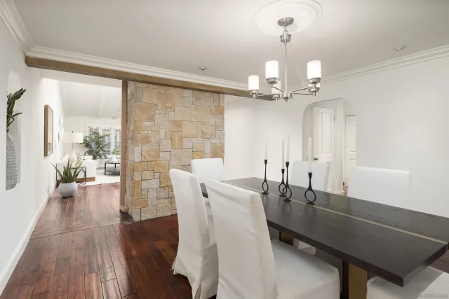 a view of a dining room with furniture and chandelier