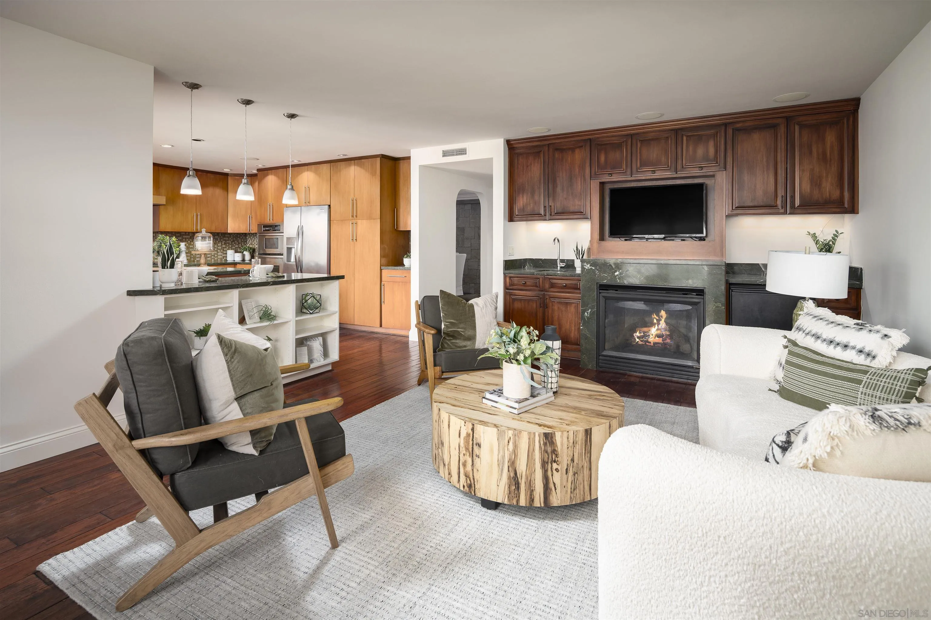 6129 La Flecha Rancho Santa Fe, CA 92067 - Photo 10 of 33 a living room with furniture a fireplace and a flat screen tv