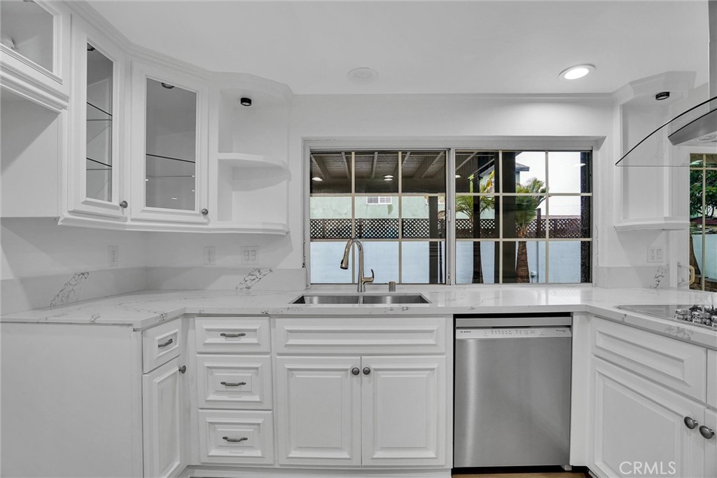 20233 Enslow Drive Carson, CA 90746 - Photo 11 of 22 a kitchen with granite countertop white cabinets and a window