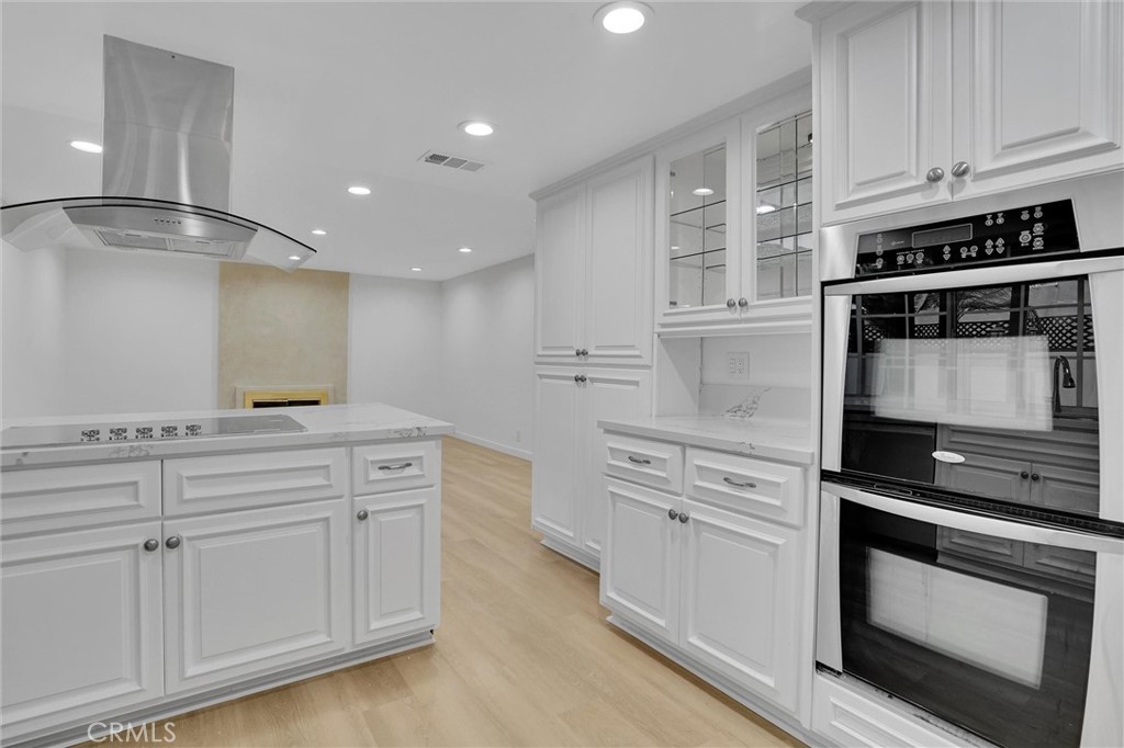 20233 Enslow Drive Carson, CA 90746 - Photo 12 of 22 a kitchen with white cabinets and appliances