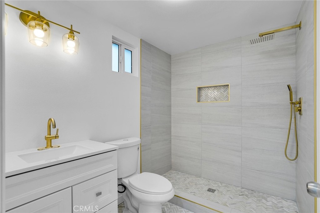 20233 Enslow Drive Carson, CA 90746 - Photo 17 of 22 a bathroom with a shower a sink a toilet and a mirror