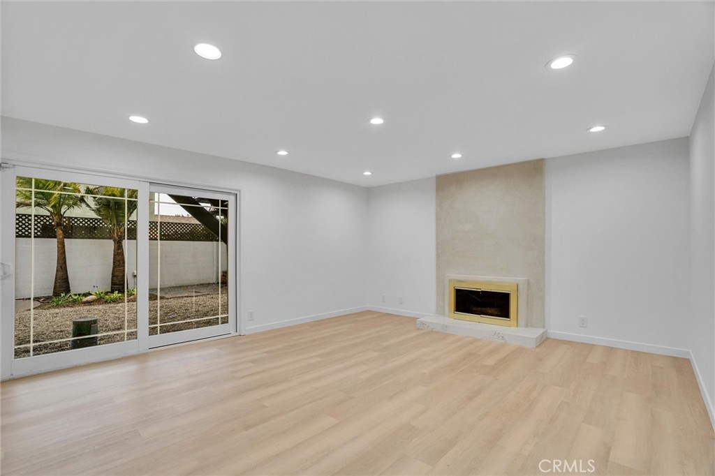 20233 Enslow Drive Carson, CA 90746 - Photo 7 of 22 an empty room with wooden floor and windows