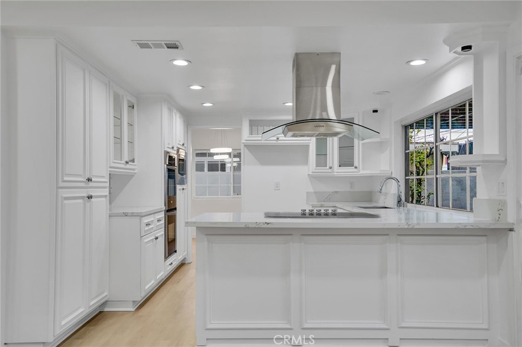 20233 Enslow Drive Carson, CA 90746 - Photo 9 of 22 a kitchen with stainless steel appliances granite countertop a sink and cabinets