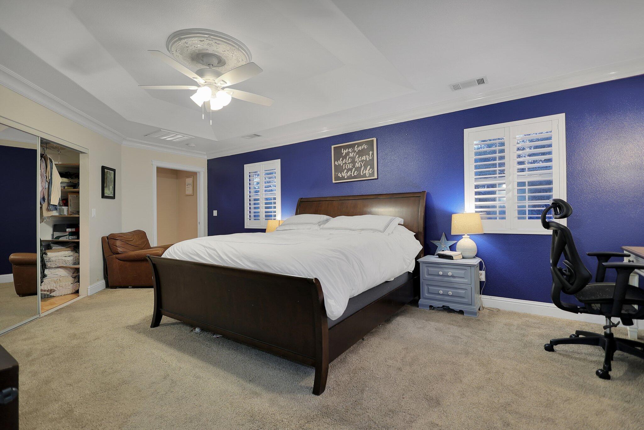 720 Lakeview Drive Redding, CA 96001 - Photo 14 of 38 a bedroom with a bed and a chandelier