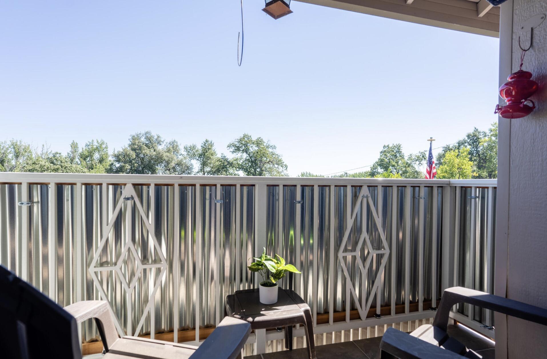 720 Lakeview Drive Redding, CA 96001 - Photo 19 of 38 a balcony with wooden floor table and chairs