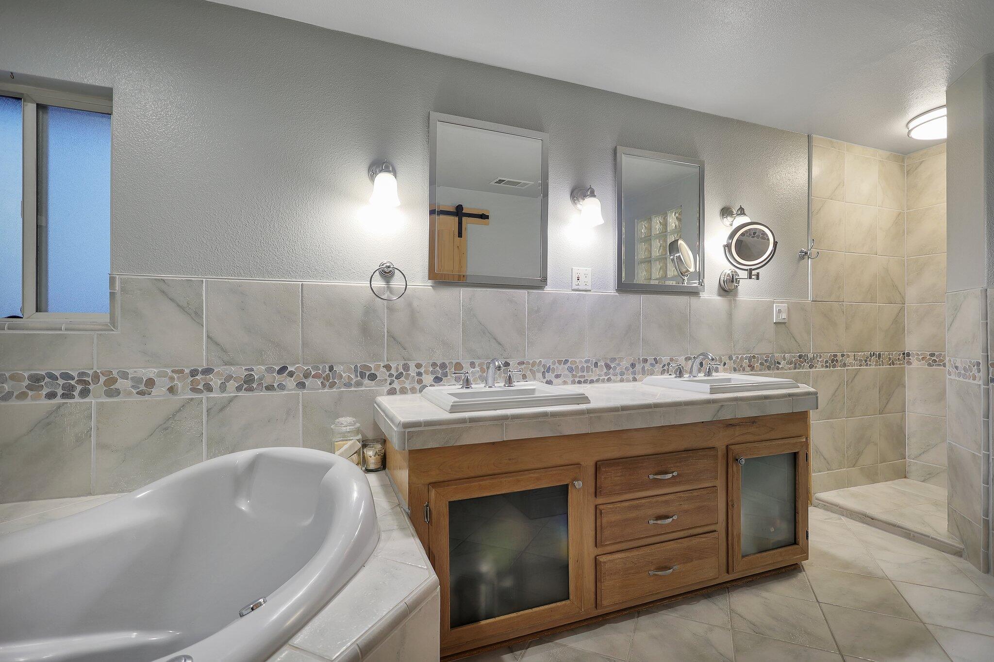 720 Lakeview Drive Redding, CA 96001 - Photo 21 of 38 a bathroom with a granite countertop sink a mirror a bathtub and shower