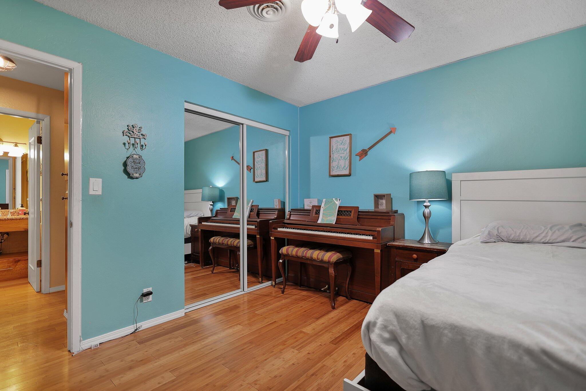 720 Lakeview Drive Redding, CA 96001 - Photo 27 of 38 a bedroom with a bed and a chandelier
