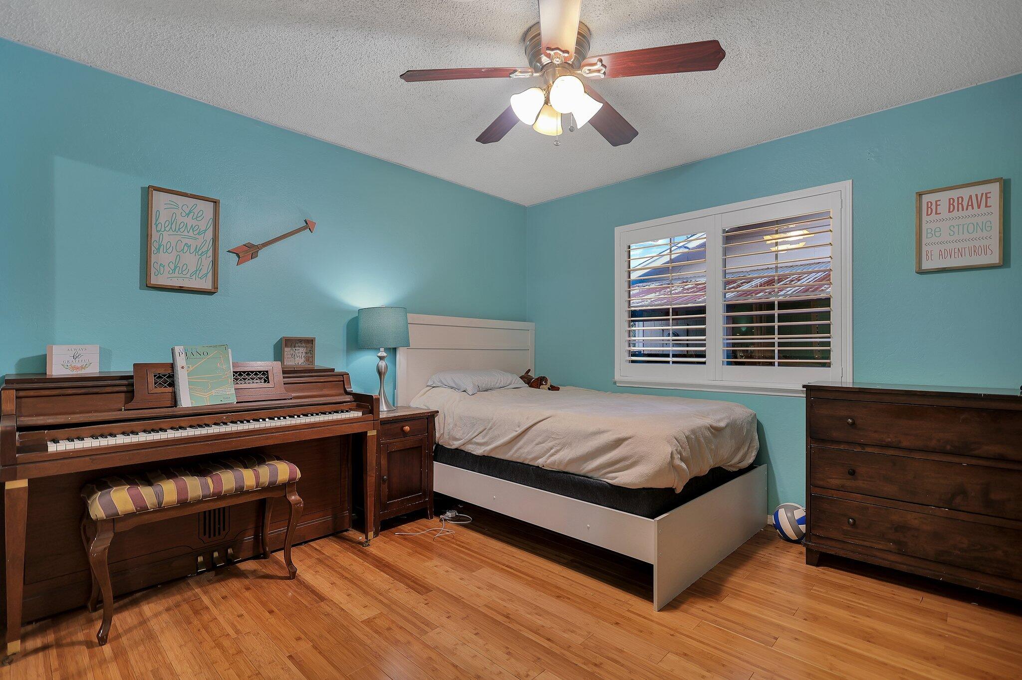 720 Lakeview Drive Redding, CA 96001 - Photo 30 of 38 a bed room with a bed and a chandelier