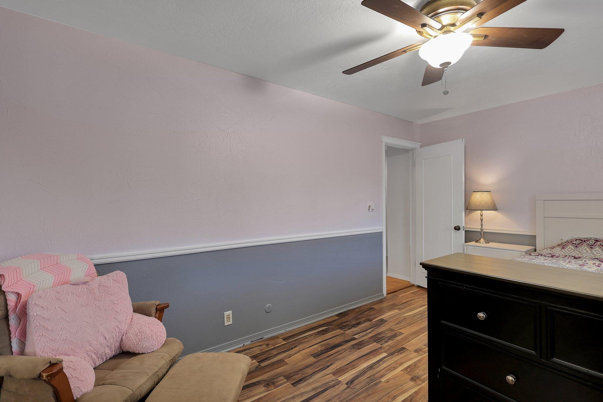 720 Lakeview Drive Redding, CA 96001 - Photo 32 of 38 a bedroom with a bed and a chandelier fan