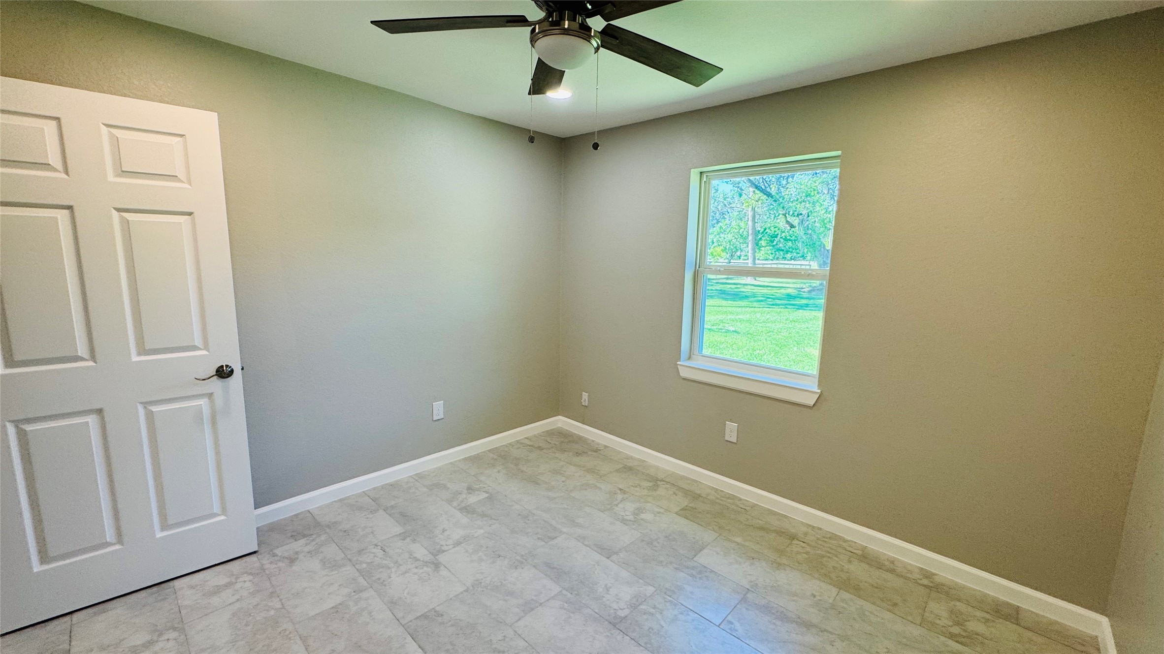 1434 County Road 878A Sweeny, TX 77480 - Photo 20 of 36 an empty room with a window and a fan