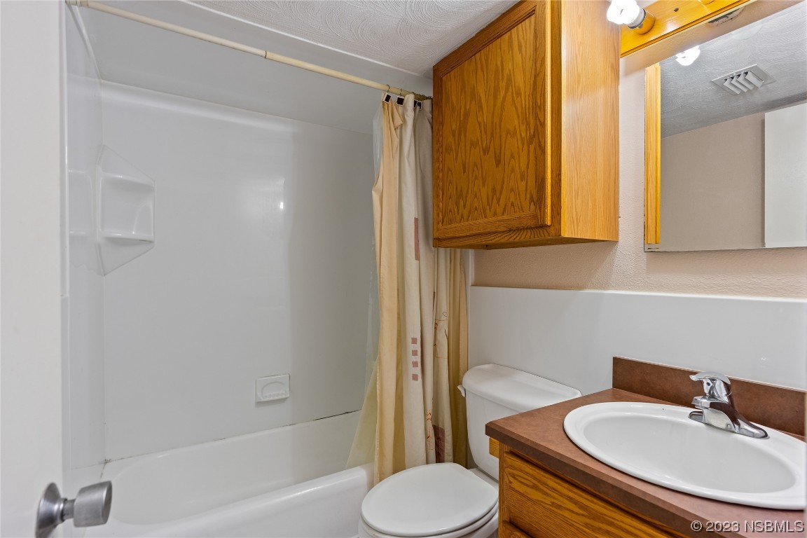 108 South Ridgewood Avenue Edgewater, FL 32132 - Photo 12 of 23 a bathroom with a sink toilet and shower
