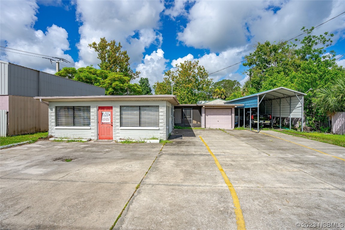 108 South Ridgewood Avenue Edgewater, FL 32132 - Photo 21 of 23 front view of a house with a patio