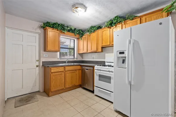an empty room with a chandelier fan and closet area
