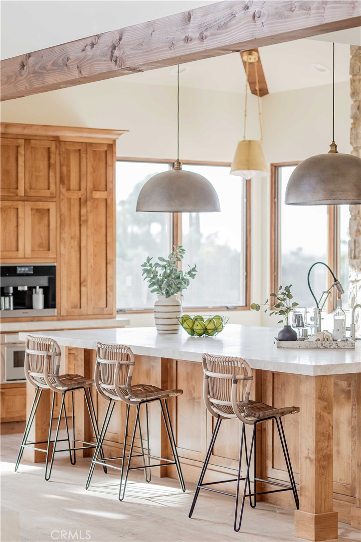 35995 Summit Circle Temecula, CA 92592 - Photo 12 of 75 a kitchen with stainless steel appliances granite countertop a stove a sink and white cabinets with wooden floor