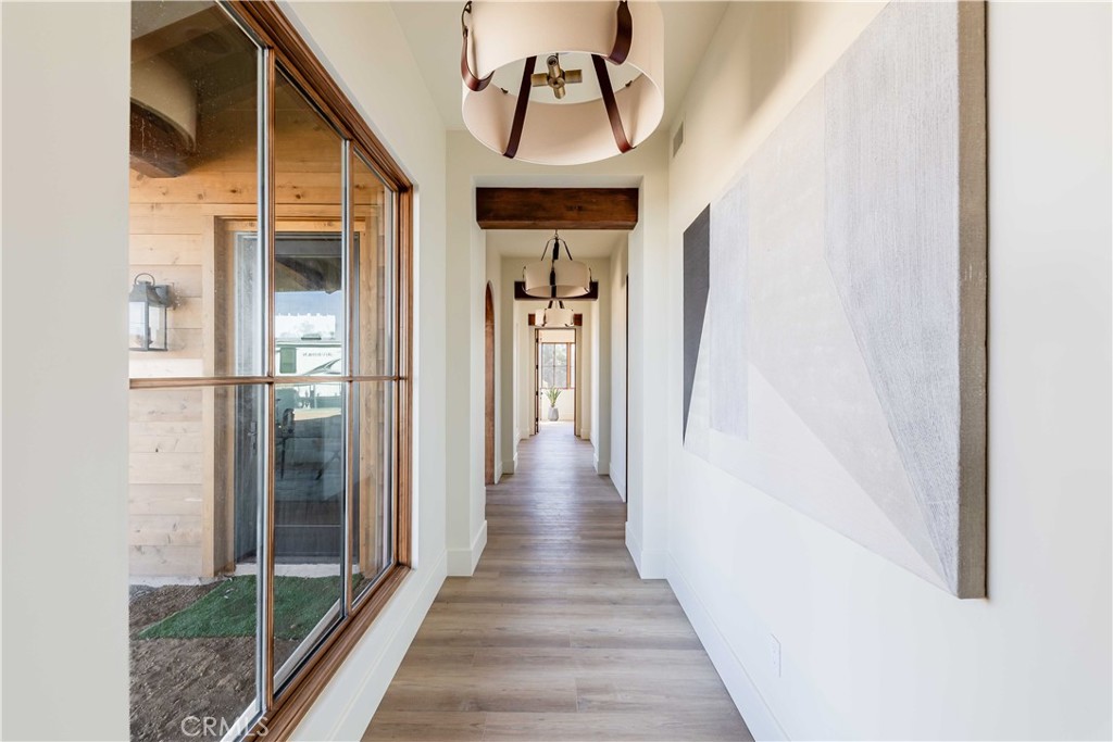 35995 Summit Circle Temecula, CA 92592 - Photo 16 of 75 a view of a hallway with wooden floor and entryway