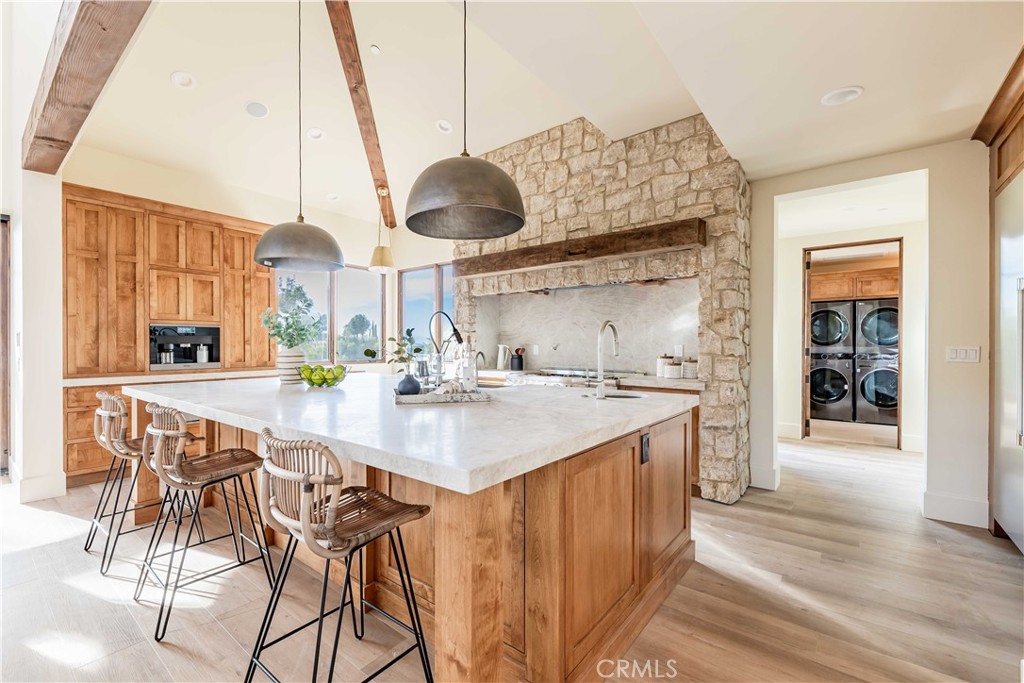 35995 Summit Circle Temecula, CA 92592 - Photo 26 of 75 a kitchen with stainless steel appliances kitchen island granite countertop a sink and cabinets