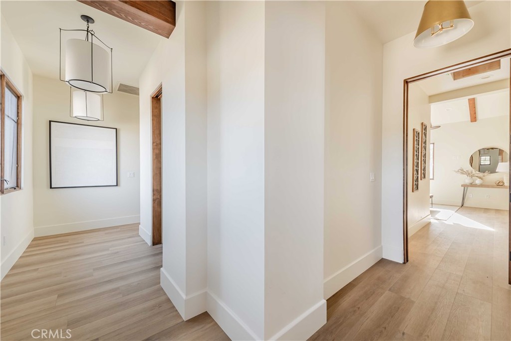 35995 Summit Circle Temecula, CA 92592 - Photo 52 of 75 a view of a hallway with wooden floor and a livingroom