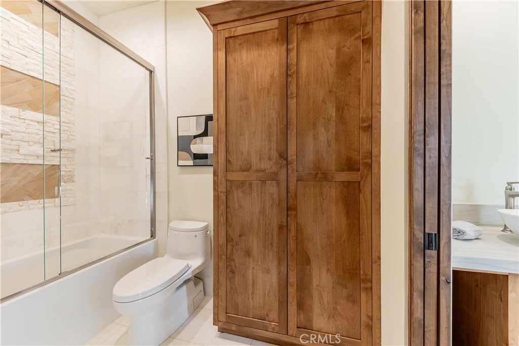 35995 Summit Circle Temecula, CA 92592 - Photo 61 of 75 a bathroom with a granite countertop toilet a sink and shower