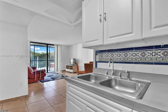 a kitchen with a sink and cabinets