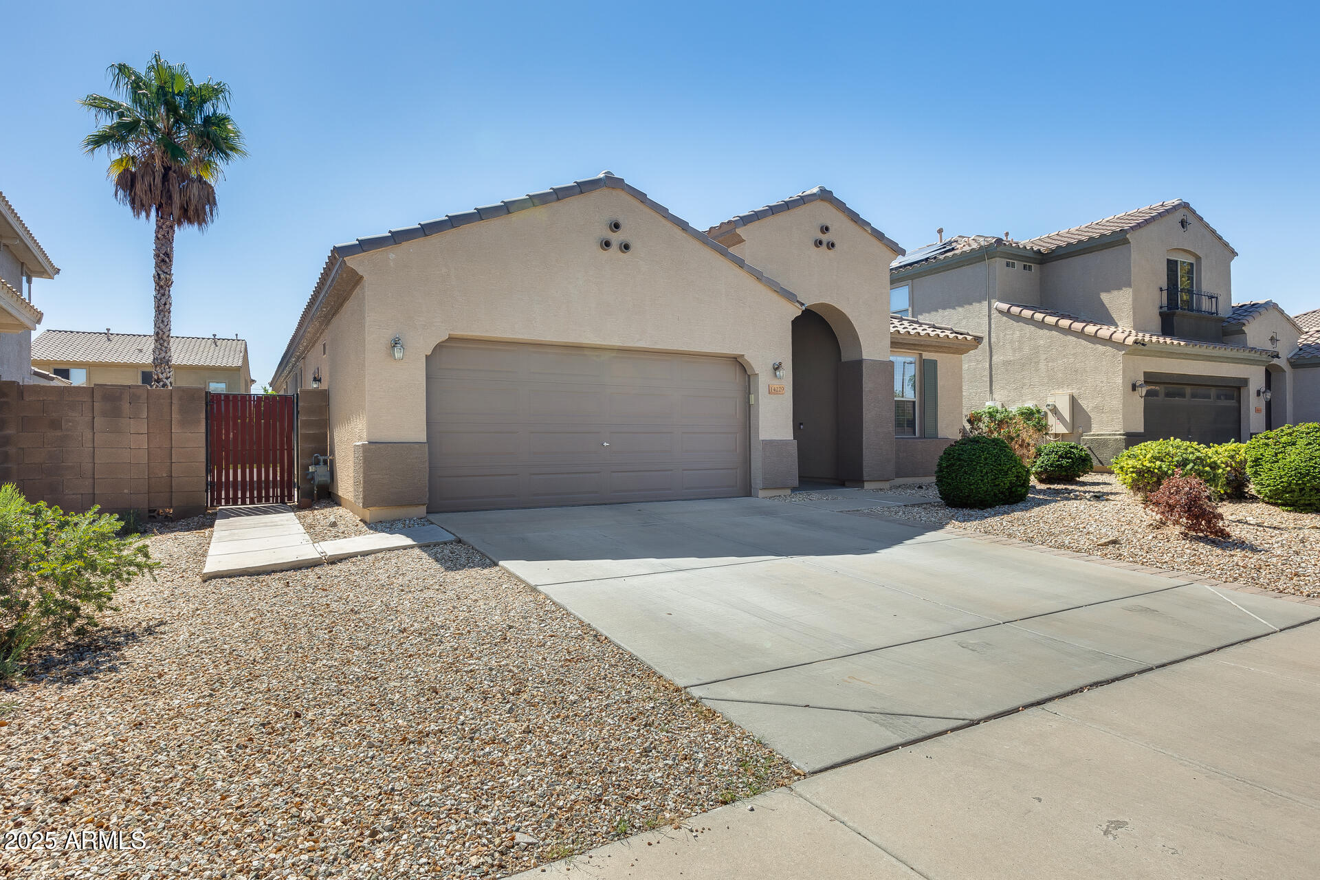 14229 West Calavar Road Surprise, AZ 85379 - Photo 6 of 44 a front view of a house with a yard