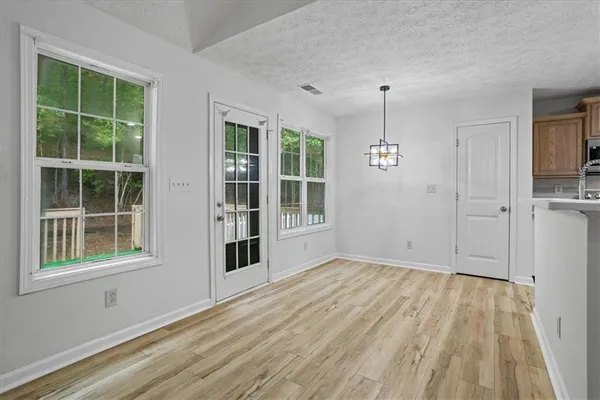 a view of empty room with windows and entryway