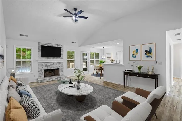 a living room with furniture and a fireplace