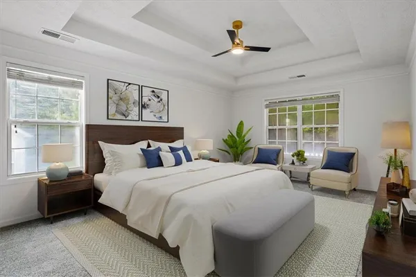 a bedroom with a bed a couch and a window