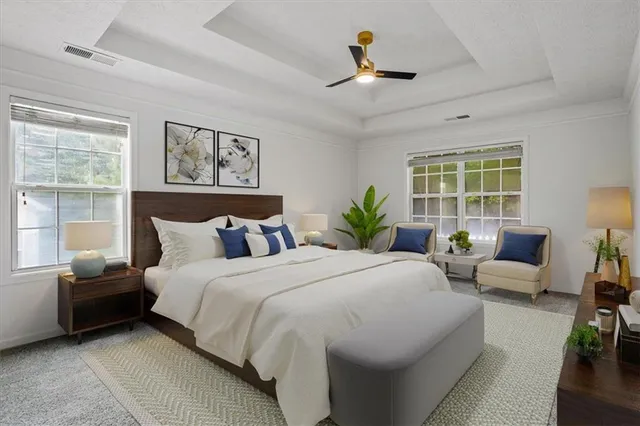 a bedroom with a bed a couch and a window