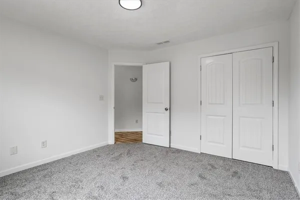 a view of an empty room and entryway