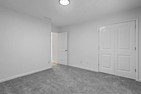 a view of an empty room and entryway