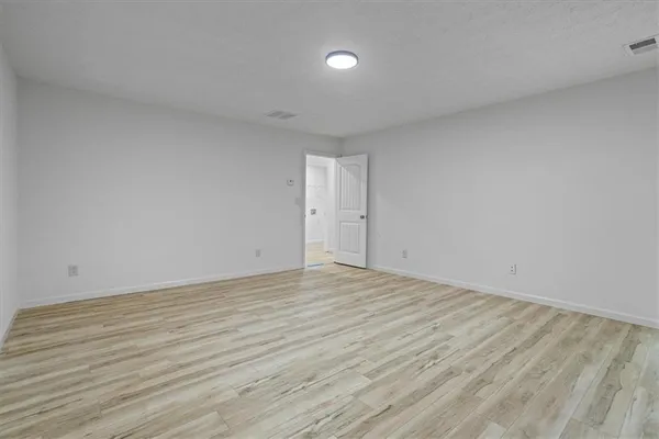 a view of an empty room and wooden floor