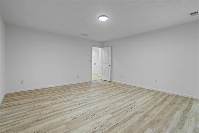 a view of an empty room and wooden floor