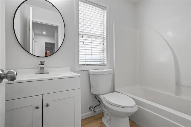 a bathroom with a toilet sink and a mirror