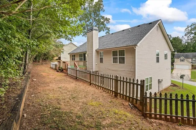 a view of a house with wooden fence