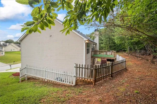 a view of backyard with deck and garden