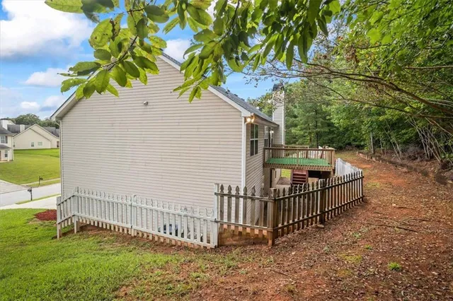 a view of backyard with deck and garden