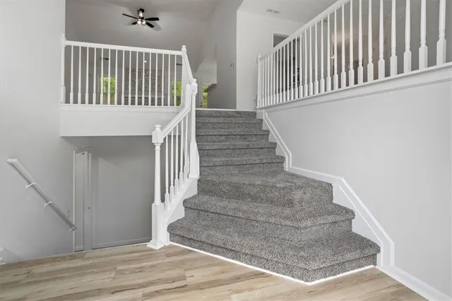 a view of staircase with white walls and a window