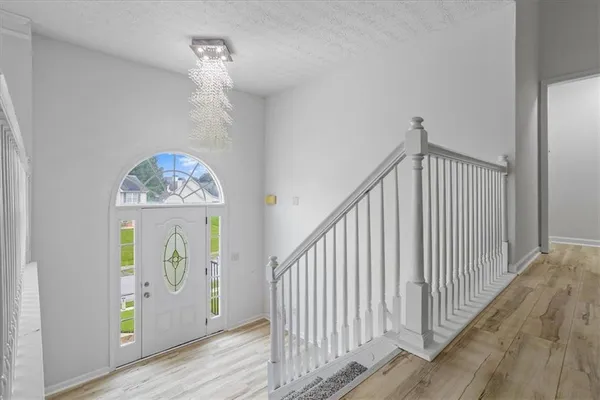 a view of an entryway with wooden floor