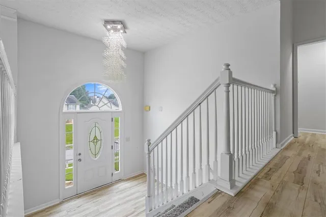 a view of an entryway with wooden floor