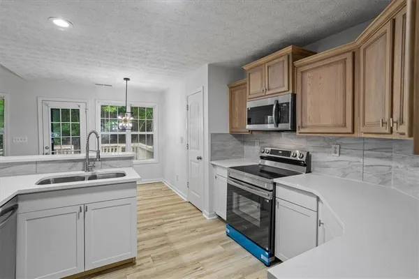 a kitchen with stainless steel appliances granite countertop a stove and a sink
