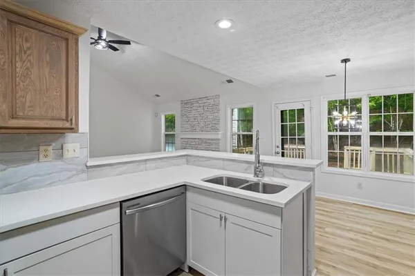 a kitchen with a sink and large window
