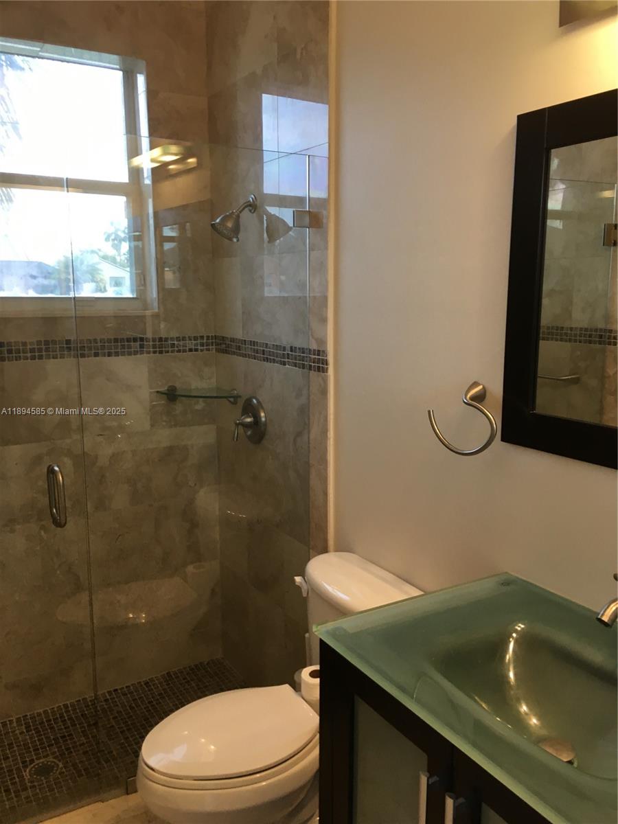 18580 Southwest 44th Street Miramar, FL 33029 - Photo 16 of 71 a bathroom with a sink a toilet and shower