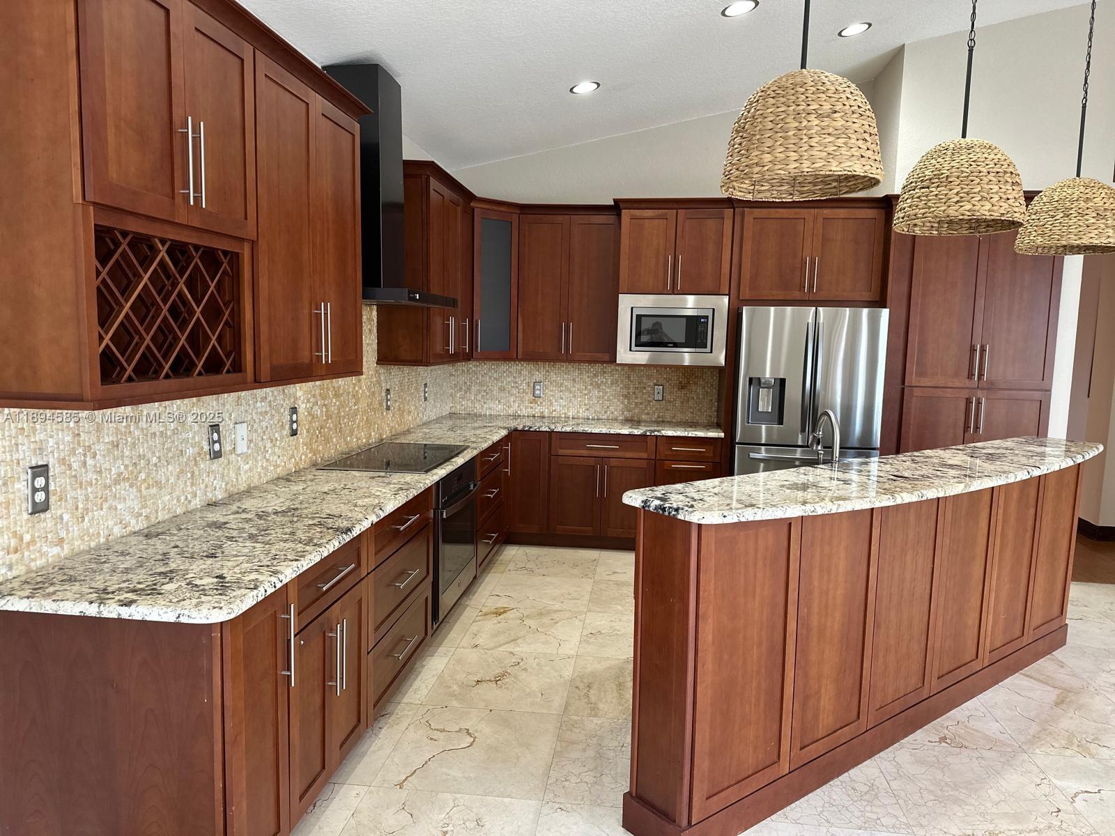 18580 Southwest 44th Street Miramar, FL 33029 - Photo 3 of 71 a kitchen with stainless steel appliances granite countertop wooden cabinets a oven and a sink
