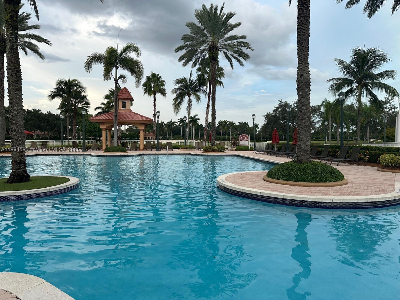 18580 Southwest 44th Street Miramar, FL 33029 - Photo 69 of 71 a view of a swimming pool with a table and chairs