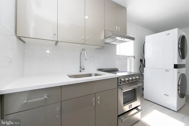 a kitchen with a refrigerator and a stove top oven