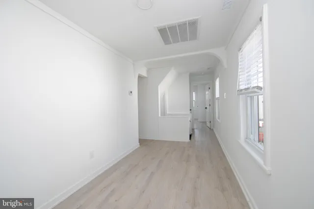 an empty room with windows and closet