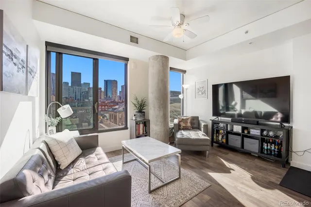 a living room with furniture and a lamp