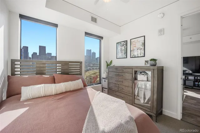 a view of a patio with couches table and chairs with wooden floor and fence