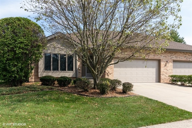 154 Bent Tree Lane New Lenox, IL 60451 - Photo 1 of 25 a front view of a house with a yard and garage