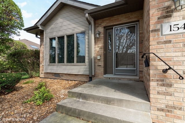 154 Bent Tree Lane New Lenox, IL 60451 - Photo 2 of 25 a front view of a house with a garage